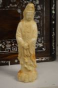 A Chinese carved soapstone figure of a female deity.