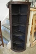 An early carved oak corner display shelf.