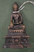 A small Chinese bronze seated deity.