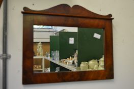 A mahogany framed mirror.