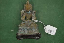 A small eastern bronze seated deity.