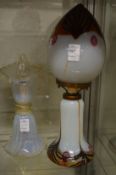 Two decorative glass lamps.