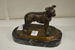 A bronze model of a dog on a marble base.