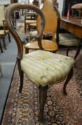 A set of four Victorian mahogany balloon back dining chairs.
