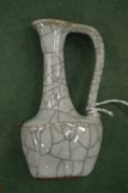 A small Chinese Celadon crackle glazed oil vessel.