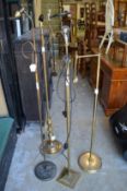 Four brass standard lamps.