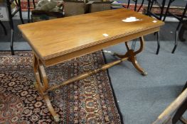 A mahogany coffee table with lyre end supports.