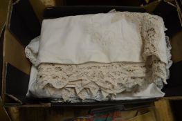 A box of white tablecloths, linen etc.