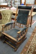 A 19th century walnut rocking chair with upholstered back, arms and seat.