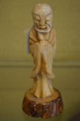 A small Chinese carved soapstone figure of a sage.