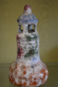 A Staffordshire sponge ware decorated model of a lighthouse.
