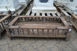 An Indian hardwood rectangular cradle or plant trough with turned spindle supports.