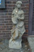A large composite garden statue of a young lady.