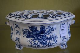 A blue and white flower pot.