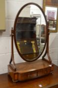 An oval mahogany dressing table mirror with two drawers to the base.