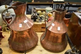 Two large eastern copper ewers.