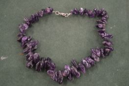 An amethyst coloured necklace.