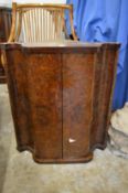 A walnut corner cabinet.