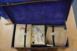 A quantity of cigarette cards etc. in a leather case.