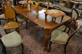 A 19th century mahogany extending dining table with two leaves on turned and reeded supports.
