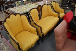 An Edwardian inlaid mahogany three-piece suite.