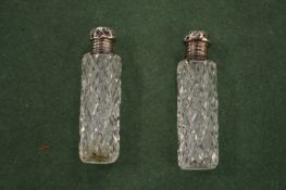 A pair of silver mounted cut glass scent bottles.