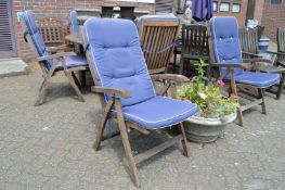 A set of six hardwood reclining armchairs.