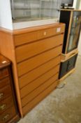 A modern teak chest of drawers.