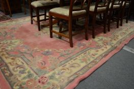 A pink ground Chinese carpet 310cms x 245cms.