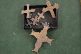 A group of bronze Roman crosses.
