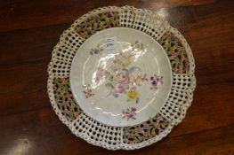 A Meissen plate with floral decoration and pierced border.