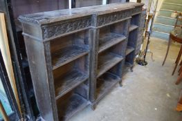 A carved oak breakfront open bookcase.