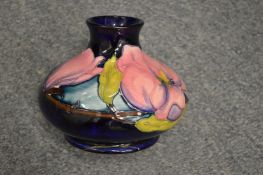 A Moorcroft squat shaped vase. ( Base cracks ).