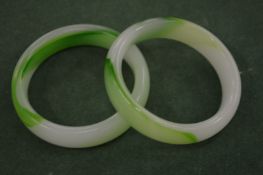 Two Chinese pale green mottled jade bangles.