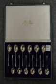 A set of twelve Mappin & Webb silver seal top coffee spoons, cased.