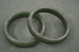Two Chinese dark green jade bangles.