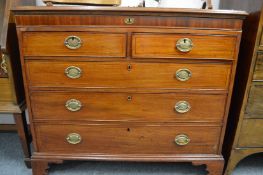 A George III mahogany chest with a narrow frieze drawer above two short and three long drawers on