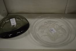An engraved glass dish and a glass ashtray.