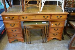 A reproduction yew wood pedestal desk.