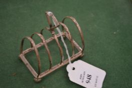 A small silver toast rack.