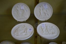 A set of four Copenhagen bisque porcelain circular plaques.