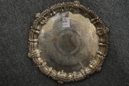 An engraved silver salver.