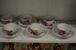 A set of six floral decorated teacups and saucers.