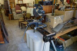 A sliding bevel compound mitre saw with folding leg assembly and extending roller supports.