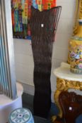 An unusual modern floor standing lamp of pierced and carved wood form.