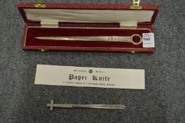 A boxed silver letter opener and another item.
