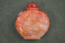 A Chinese carved russet jade bat snuff bottle.
