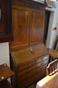 A George III oak and mahogany cross-banded bureau bookcase.