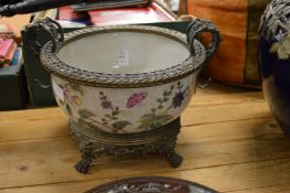 A decorative pottery bowl with ormolu mounts and stand.