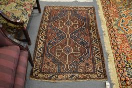 A small Persian rug 135cms x 90cms.